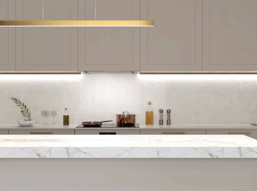 Modern minimalist kitchen featuring a thick marble countertop island with under-cabinet lighting, brass pendant light, and sleek cabinetry - illustrating countertop thickness considerations.