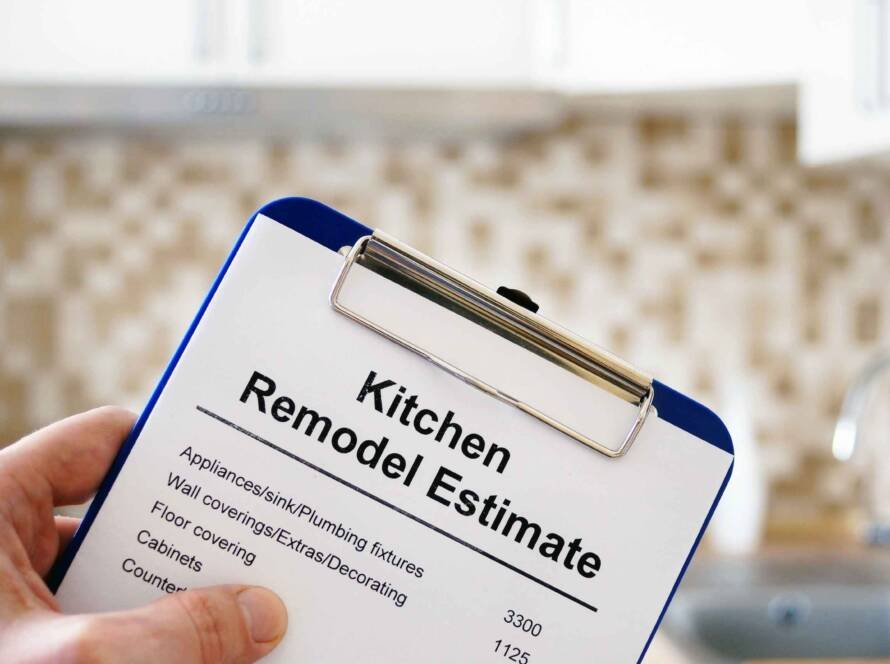 Kitchen remodel estimate displayed on a clipboard in a modern kitchen.