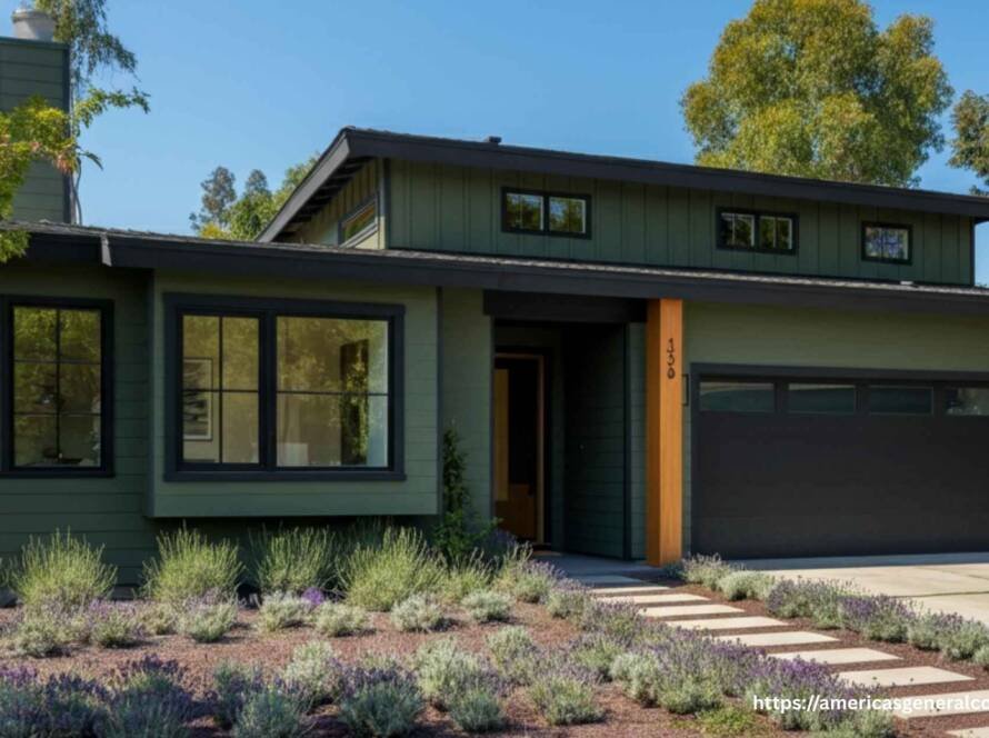 Modernized 1970 ranch house with updated facade, featuring large windows, deep green paint, black trim, and drought-tolerant landscaping.