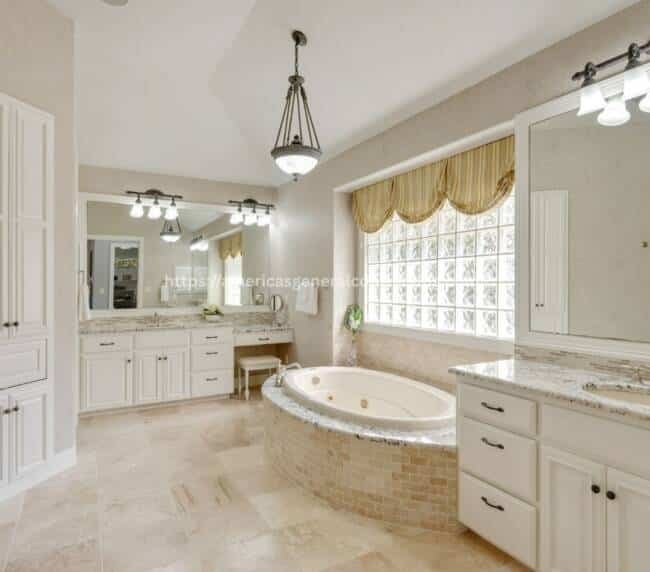 Luxurious bathroom with a marble-surrounded bathtub, granite vanity, and elegant lighting, exemplifying bathroom remodeling Dallas expertise