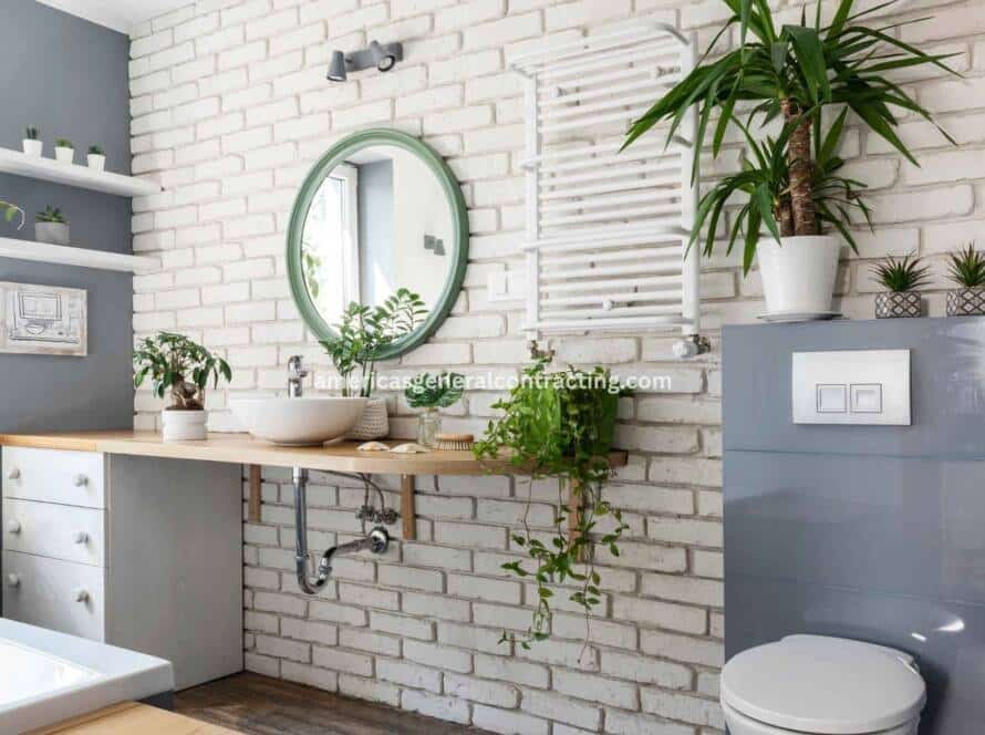 Modern bathroom with natural elements, featuring a wooden countertop, white sink basin, green-framed mirror, and fresh plants, showcasing the design quality of the best bathroom remodeler near me.