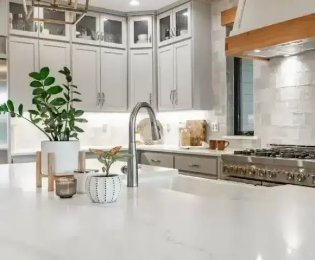 Luxury kitchen remodeling in Dallas with custom white shaker cabinets, quartz countertops, and stainless steel appliances